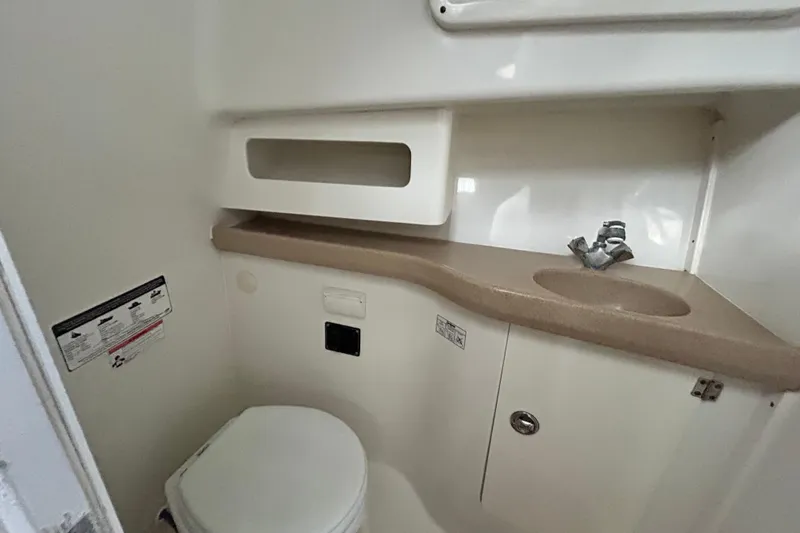 Slide: The Image of 2007 Pro-Line 32 Express boat bathroom with sink, toilet, and storage. - 76