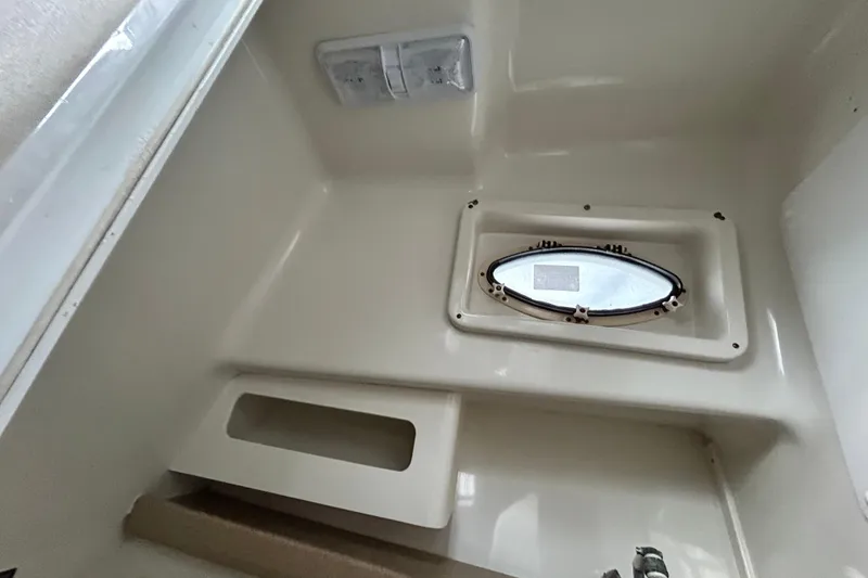 Slide: The Image of 2007 Pro-Line 32 Express cabin interior with oval window and storage compartment. - 77