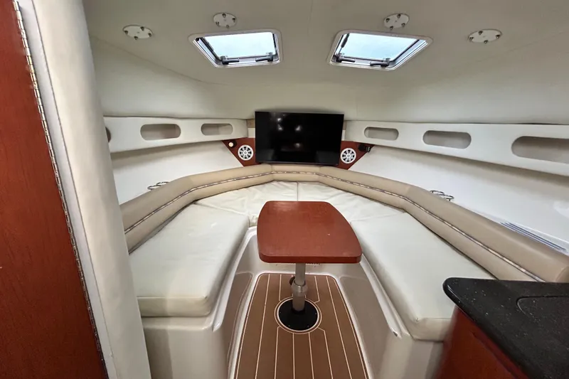 Slide: The Image of 2007 Pro-Line 32 Express cabin interior with seating, table, and TV. - 78