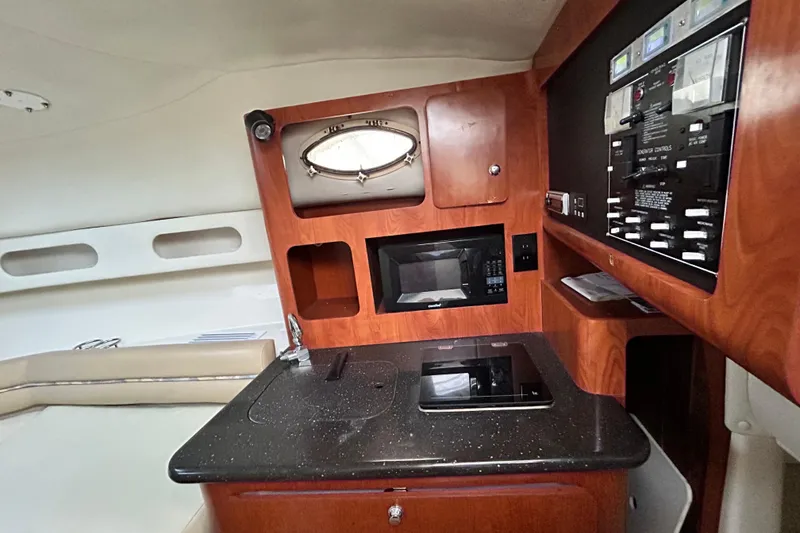 Slide: The Image of Interior of 2007 Pro-Line 32 Express boat with kitchenette and control panel. - 79