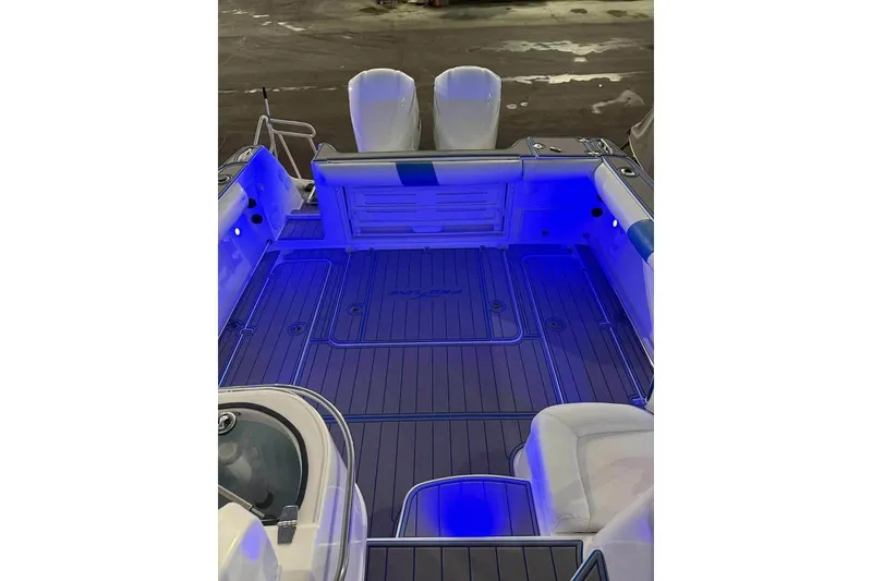 Slide: The Image of 2007 Pro-Line 32 Express boat interior with blue LED lighting and spacious deck. - 8