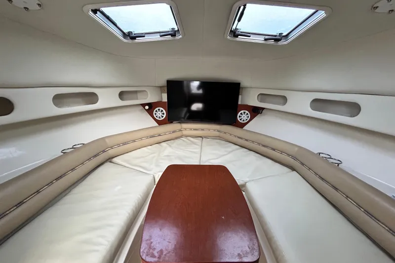 Slide: The Image of 2007 Pro-Line 32 Express cabin interior with seating, table, and TV. - 80