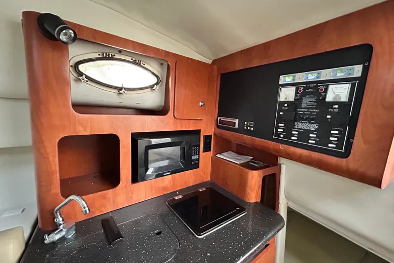 Slide: The Image of 2007 Pro-Line 32 Express cabin interior with microwave, control panel, and porthole window. - 83