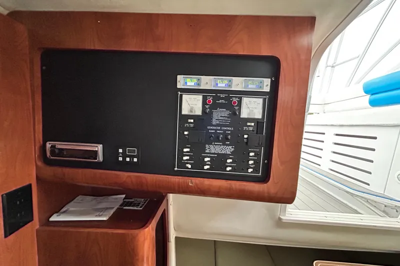 Slide: The Image of Control panel inside 2007 Pro-Line 32 Express boat, featuring generator controls and gauges. - 84