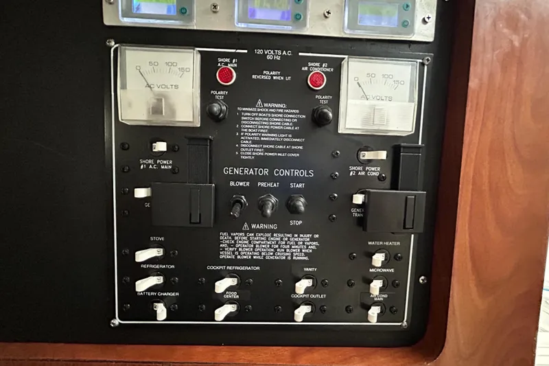 Slide: The Image of Control panel of a 2007 Pro-Line 32 Express boat with generator controls and voltage meters. - 85