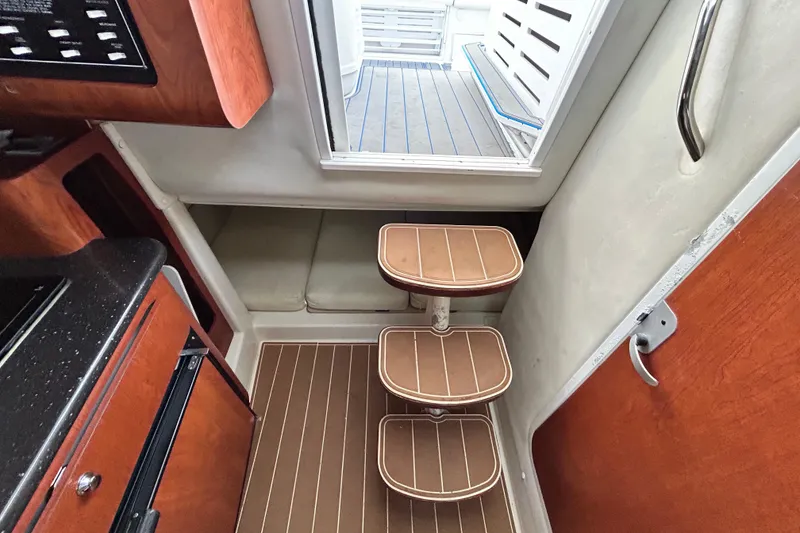 Slide: The Image of Interior of 2007 Pro-Line 32 Express boat with wooden steps and compact design. - 86