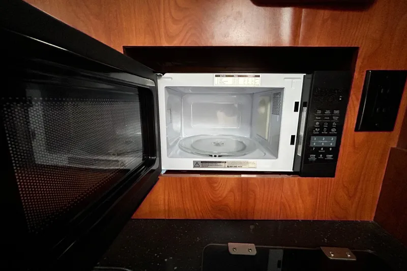 Slide: The Image of Microwave oven in 2007 Pro-Line 32 Express boat kitchen, open door, wood paneling background. - 88
