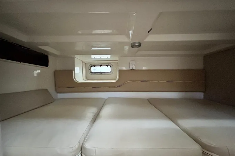 Slide: The Image of 2007 Pro-Line 32 Express cabin interior with beige cushions and small window. - 91