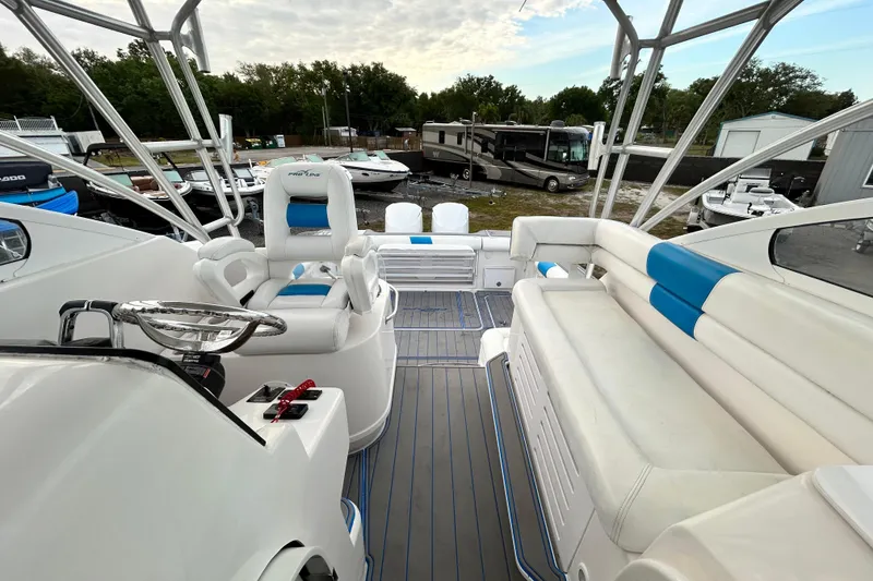 Slide: The Image of 2007 Pro-Line 32 Express boat interior with white and blue seating, steering wheel, and controls. - 95