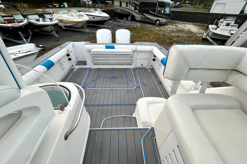Slide: The Image of 2007 Pro-Line 32 Express boat interior with white seating and spacious deck area. - 99