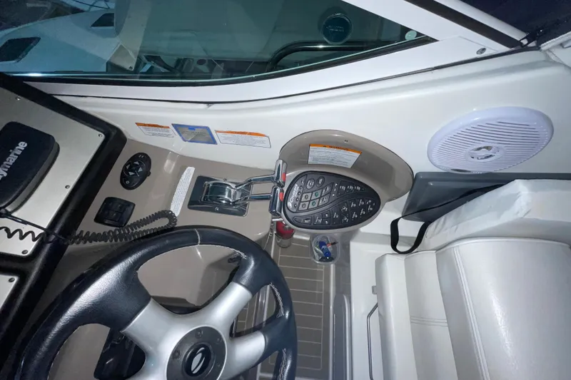 Slide: The Image of 2008 CRUISERS INC 415 Express Motoryacht helm with steering wheel and control panel. - 12