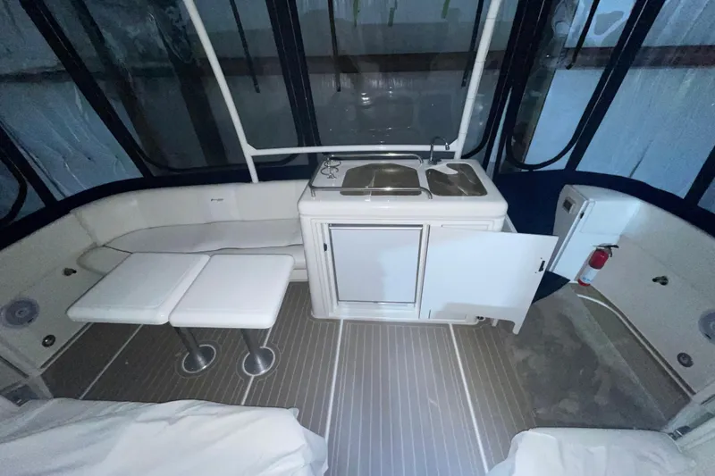 Slide: The Image of 2008 CRUISERS INC 415 Express Motoryacht interior with kitchenette and seating area. - 13