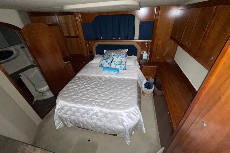 Slide: The Image of Luxurious bedroom in 2008 CRUISERS INC 415 Express Motoryacht with elegant wood cabinetry. - 17