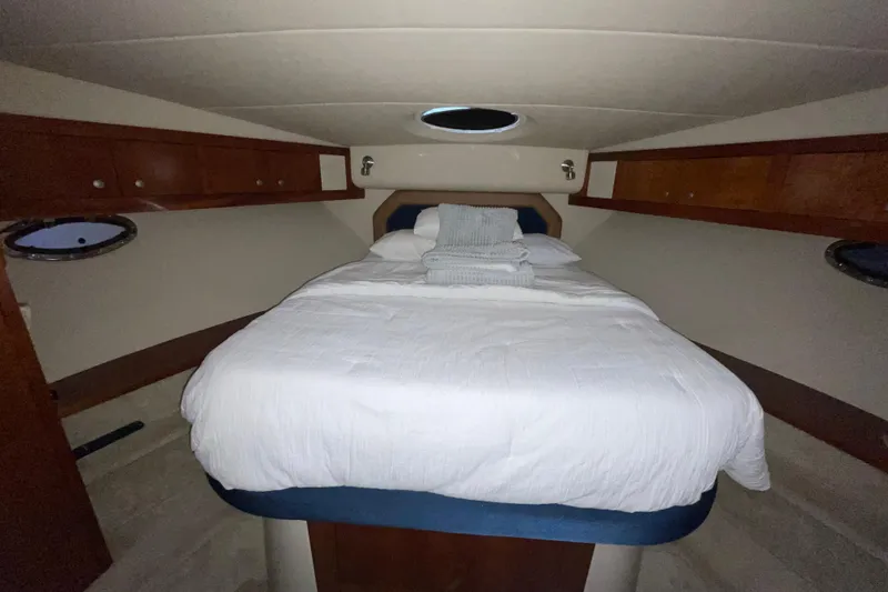 Slide: The Image of Interior cabin of 2008 CRUISERS INC 415 Express Motoryacht with cozy bed and wooden storage. - 24