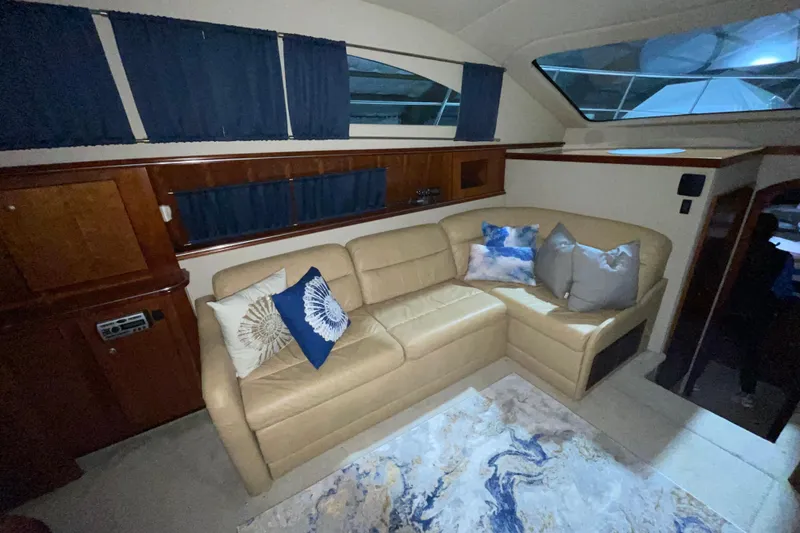 Slide: The Image of Luxurious interior of 2008 CRUISERS INC 415 Express Motoryacht with beige leather sofa and decorative pillows. - 25