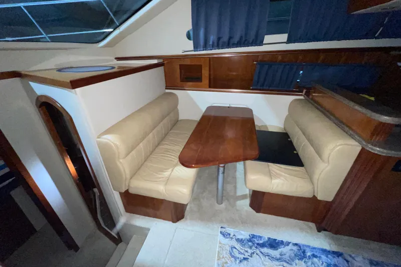 Slide: The Image of Interior of 2008 CRUISERS INC 415 Express Motoryacht with dining area and beige seating. - 26