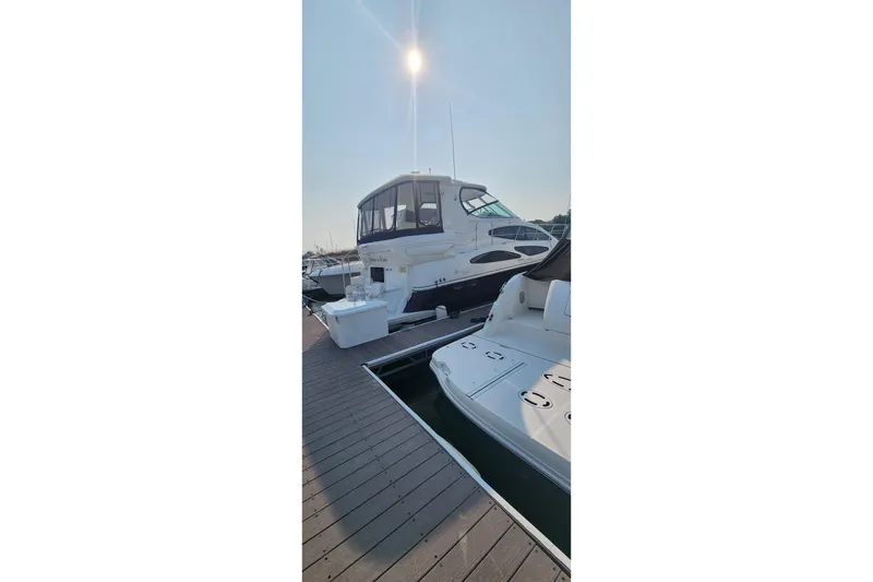 Slide: The Image of 2008 CRUISERS INC 415 Express Motoryacht docked under bright sun. - 3