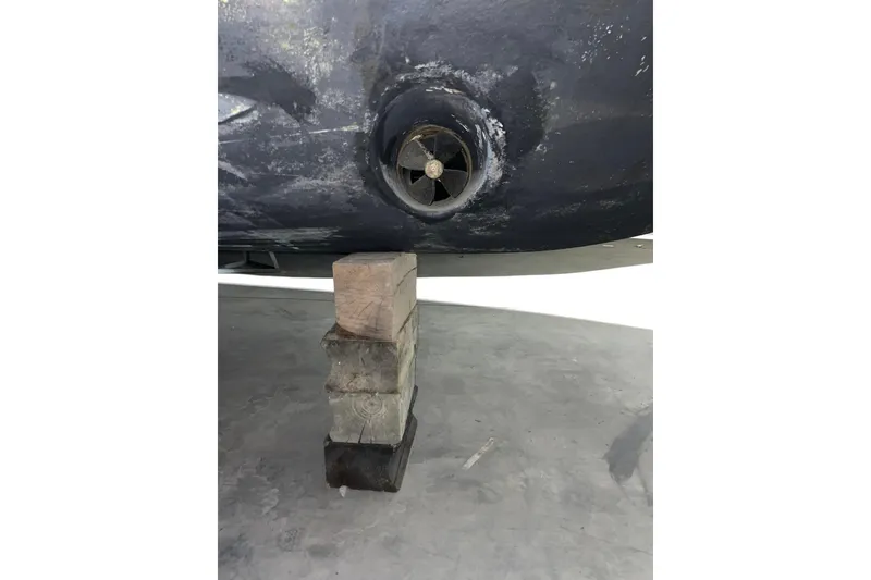 Slide: The Image of 2008 CRUISERS INC 415 Express Motoryacht hull with propeller, supported by wooden blocks. - 32