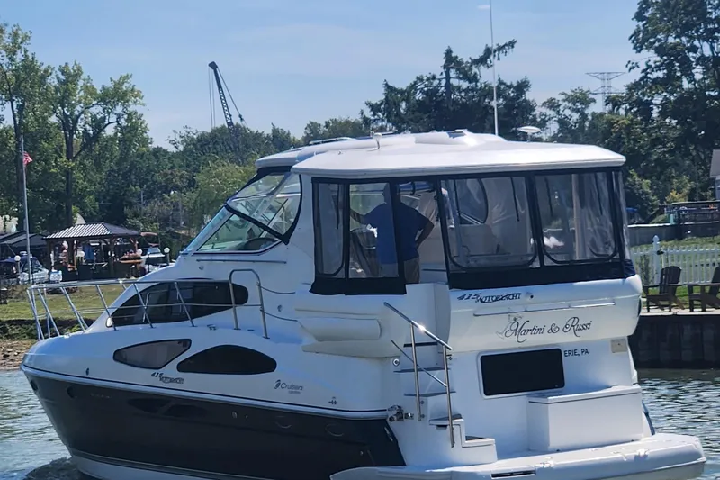 Slide: The Image of 2008 CRUISERS INC 415 Express Motoryacht docked near a scenic waterfront. - 4