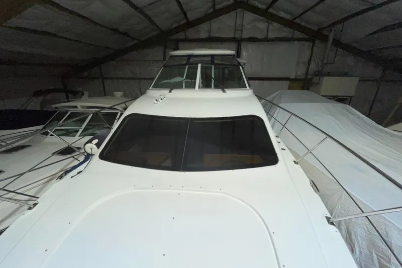 Slide: The Image of 2008 CRUISERS INC 415 Express Motoryacht in storage, showcasing sleek design and spacious deck. - 6
