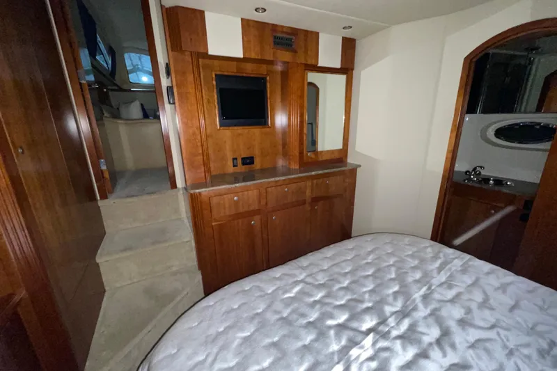 Slide: The Image of Luxurious 2008 CRUISERS INC 415 Express Motoryacht interior with wood cabinetry and cozy bedroom. - 18