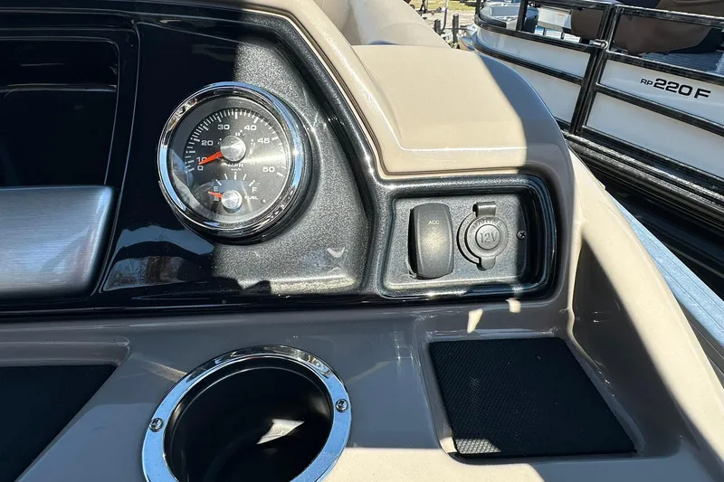 Slide: The Image of 2024 Ranger Reata 200C dashboard with speedometer and 12V accessory outlet. - 11