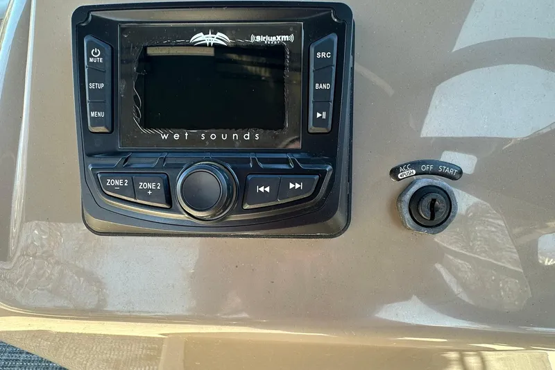 Slide: The Image of 2024 Ranger Reata 200C dashboard with audio controls and ignition switch. - 13