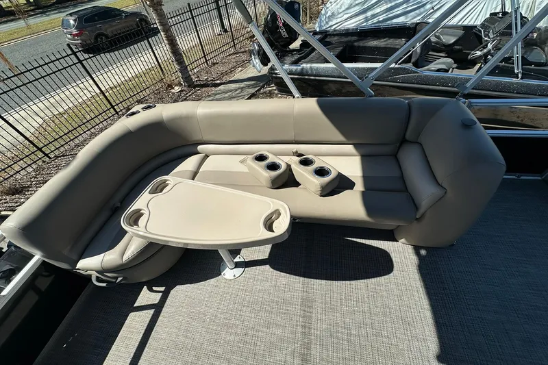 Slide: The Image of 2024 Ranger Reata 200C boat interior with beige seating and cup holders. - 15