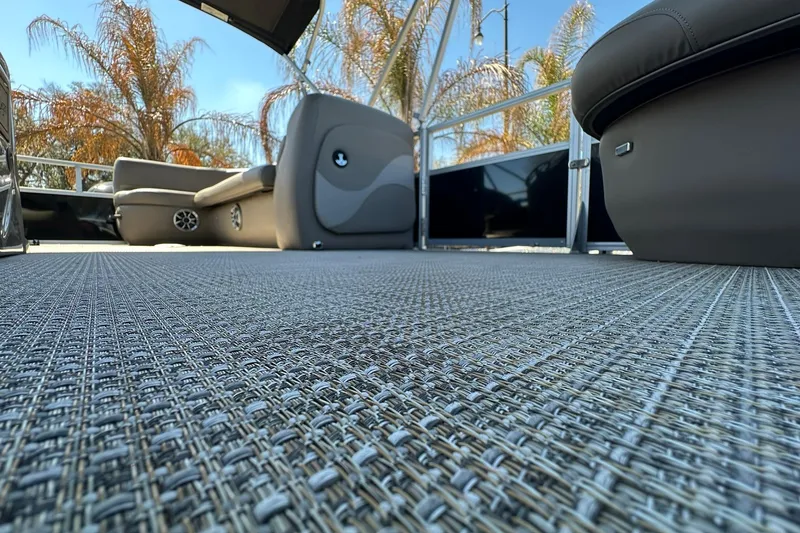 Slide: The Image of 2024 Ranger Reata 200C boat interior with woven flooring and comfortable seating. - 23