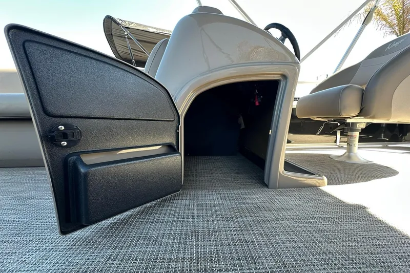 Slide: The Image of 2024 Ranger Reata 200C boat interior with open storage compartment and seating. - 24