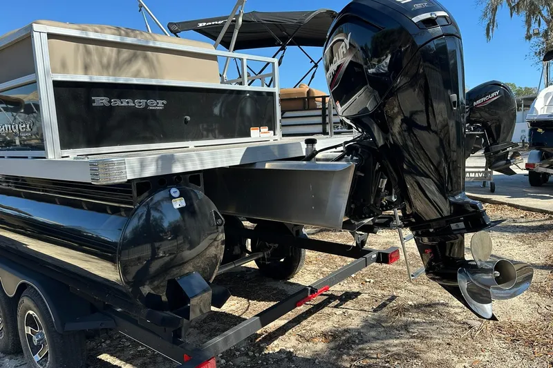 Slide: The Image of 2024 Ranger Reata 200C pontoon boat with Mercury outboard motor on trailer. - 31