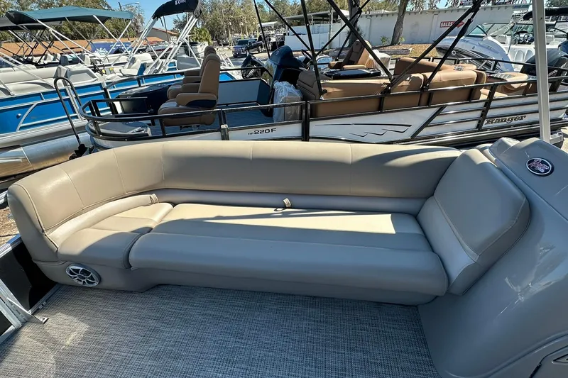 Slide: The Image of 2024 Ranger Reata 200C boat interior with beige seating and modern design. - 5