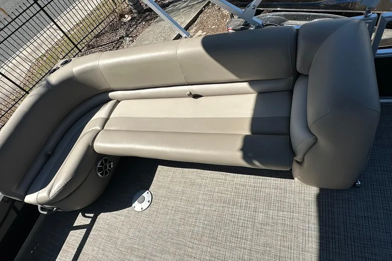 Slide: The Image of 2024 Ranger Reata 200C boat interior with beige seating and carpeted floor. - 8