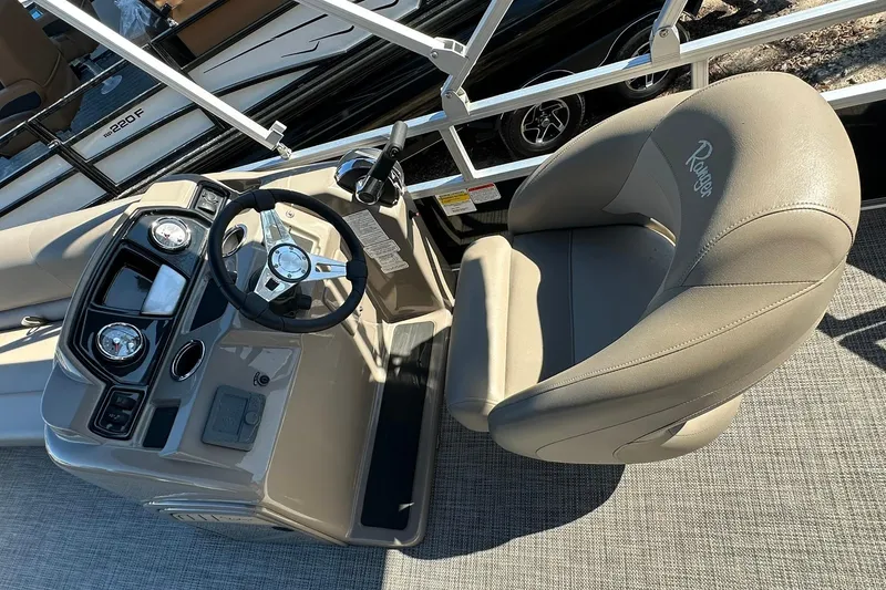 Slide: The Image of 2024 Ranger Reata 200C boat helm with steering wheel and captain's chair. - 9