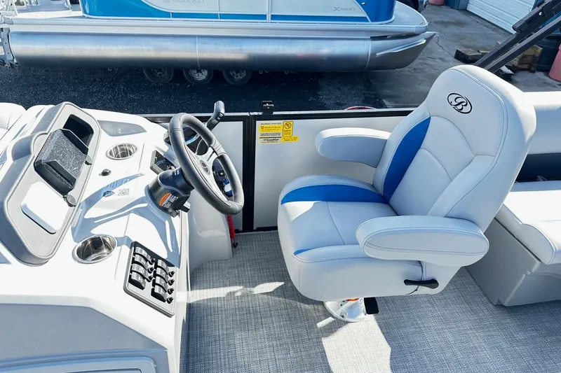 Slide: The Image of Interior of 2025 Bentley 223 Bolt Tri Toon boat with steering wheel and captain's chair. - 5