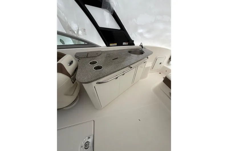 Slide: The Image of 2016 Chaparral 264 Sunesta boat cockpit with steering wheel and control panel. - 12