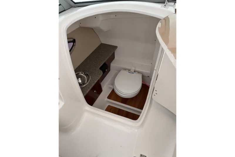 Slide: The Image of 2016 Chaparral 264 Sunesta thruster control on brown leather panel. - 15