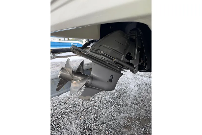 Slide: The Image of 2016 Chaparral 264 Sunesta boat propeller and outdrive on gravel surface. - 17