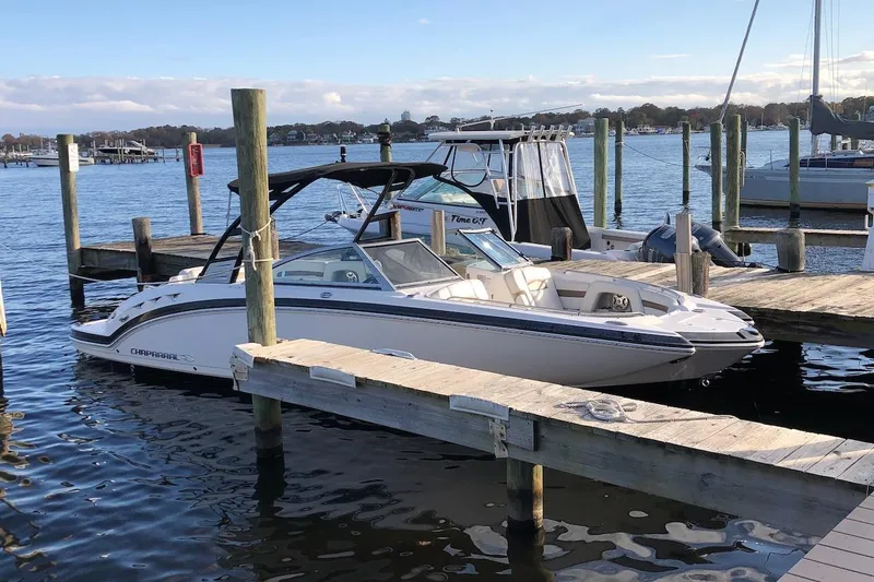 Slide: The Image of 2016 Chaparral 264 Sunesta boat with spacious seating on calm water. - 6