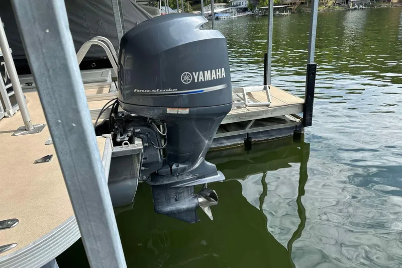 Slide: The Image of Yamaha four-stroke outboard motor on 2013 SunCatcher V322 RC pontoon boat at dock. - 10