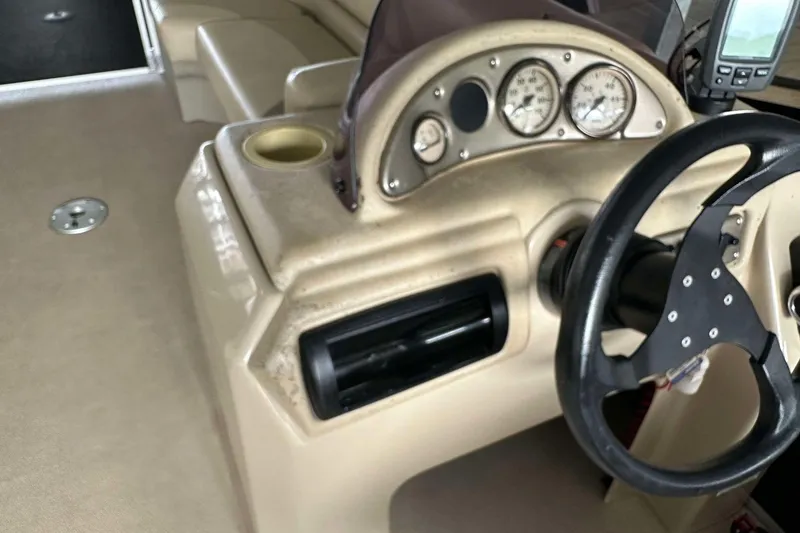Slide: The Image of 2013 SunCatcher V322 RC boat dashboard with steering wheel and gauges. - 12
