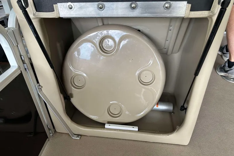 Slide: The Image of Storage compartment in a 2013 SunCatcher V322 RC boat, featuring a round lid. - 15
