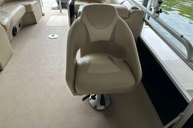 Slide: The Image of 2013 SunCatcher V322 RC boat interior with beige seating and carpeted floor. - 18