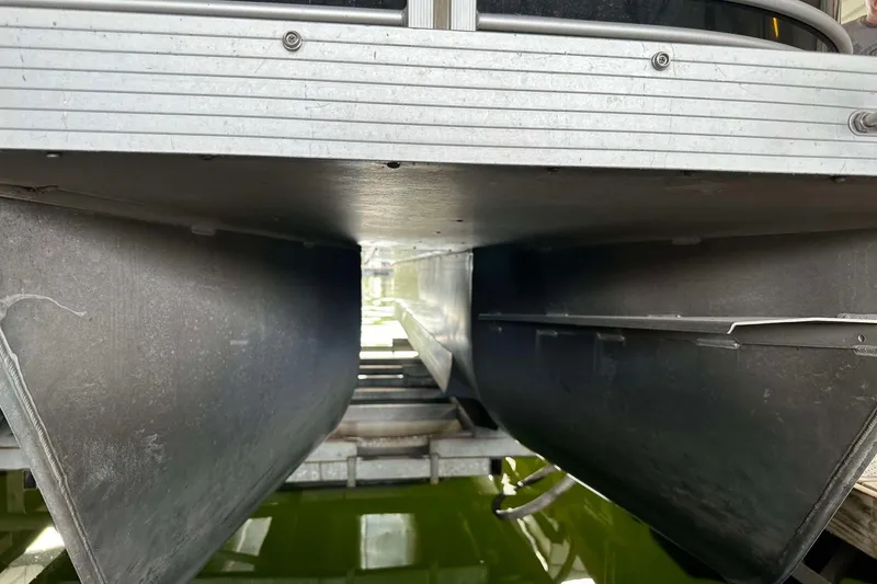 Slide: The Image of Underneath view of a 2013 SunCatcher V322 RC pontoon boat on water. - 21