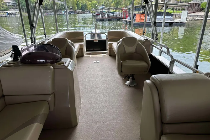 Slide: The Image of 2013 SunCatcher V322 RC pontoon boat interior with beige seating and lake view. - 22