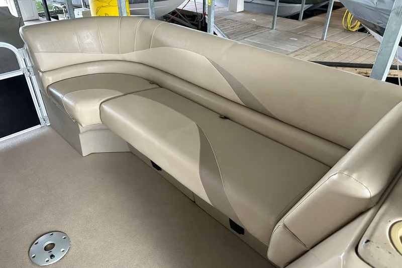 Slide: The Image of 2013 SunCatcher V322 RC boat interior with beige seating and storage compartments. - 3