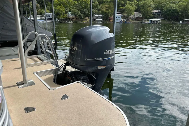 Slide: The Image of 2013 SunCatcher V322 RC pontoon boat with Yamaha 150 outboard motor on a lake. - 7