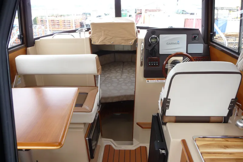 Slide: The Image of Interior of 2017 Ranger Tugs R-23 boat with helm, seating, and navigation equipment. - 10