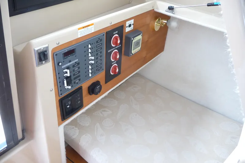 Slide: The Image of 2017 Ranger Tugs R-23 control panel with switches and dials in cabin interior. - 19