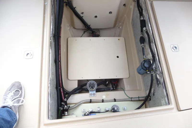 Slide: The Image of 2017 Ranger Tugs R-23 engine compartment with visible wiring and components. - 28